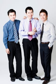 Portrait of three businessmen standing and smiling
