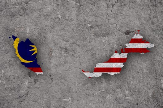 Map and flag of Malaysia on weathered concrete
