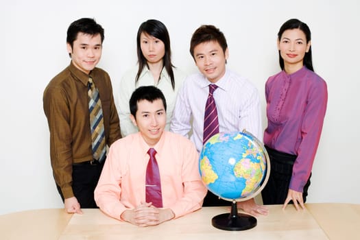 Portrait of two businesswomen and three businessmen smiling