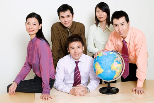Portrait of two businesswomen and three businessmen smiling