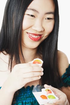 Close-up of a young woman holding a candy box