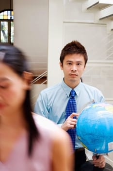 Portrait of a businessman holding a globe