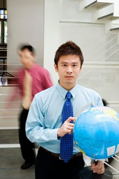 Portrait of a businessman holding a globe