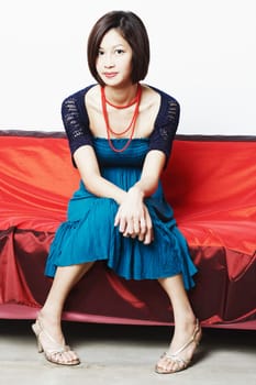 Portrait of a young woman sitting on a couch