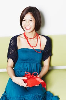 Portrait of a young woman holding a gift