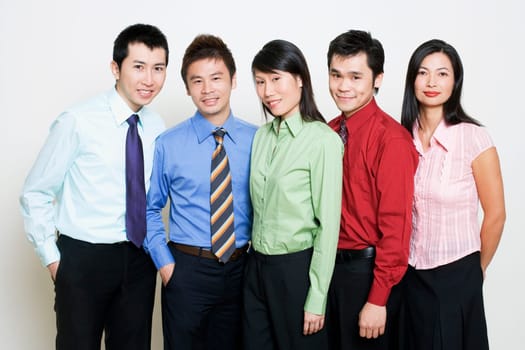Portrait of five business executives standing together and smiling