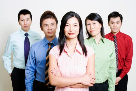 Portrait of five business executives standing together and smiling