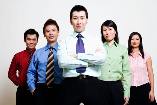Portrait of five business executives standing together and smiling