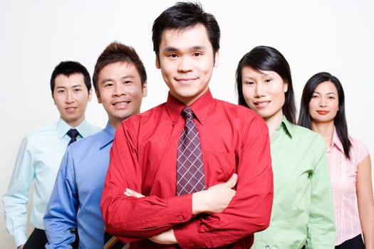 Portrait of five business executives standing together and smiling