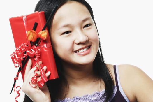 Portrait of a teenage girl holding a gift