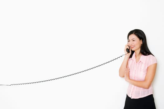 Mid adult woman talking on the telephone