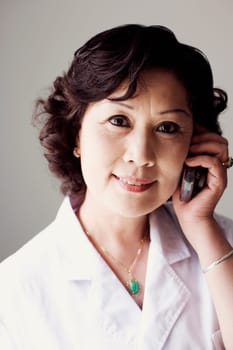 Close-up of a female doctor talking on a mobile phone