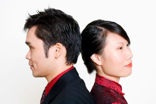 Side profile of a mid adult man and a young woman smiling