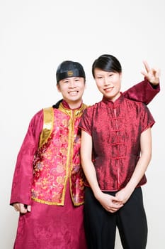Young woman smiling with a young man making a peace sign