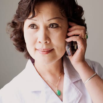 Close-up of a female doctor talking on a mobile phone
