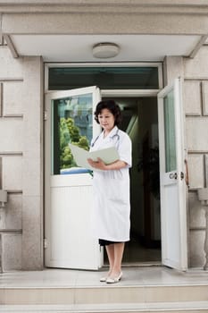 Female doctor reading a report