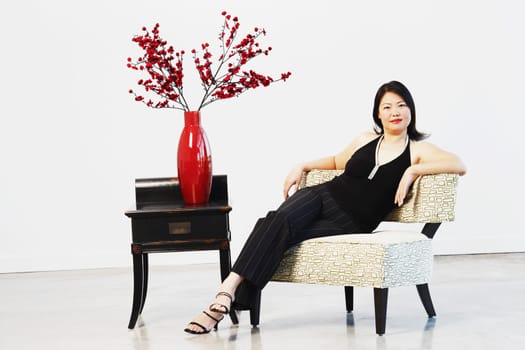 Portrait of a mid adult woman sitting on a chair