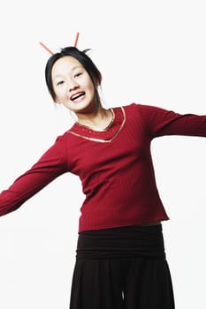 Portrait of a teenage girl standing with her arms outstretched