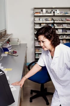 Close-up of a female pharmacist in a store room