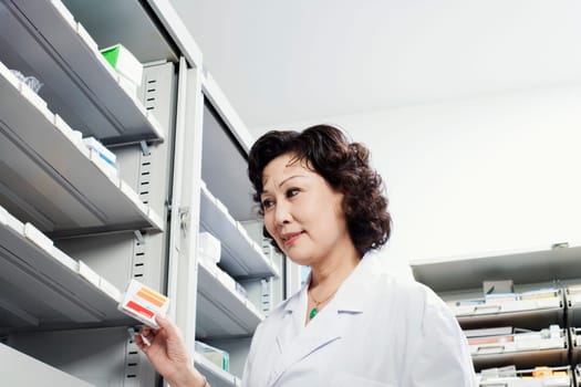 Close-up of a female pharmacist in a store room