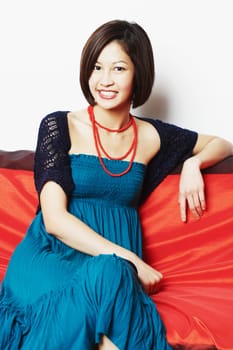 Portrait of a young woman sitting on a couch