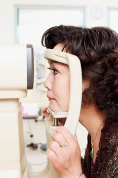 Side profile of a patient being examined with an ophthalmoscope
