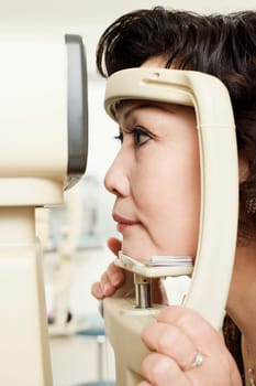 Side profile of a patient being examined with an ophthalmoscope