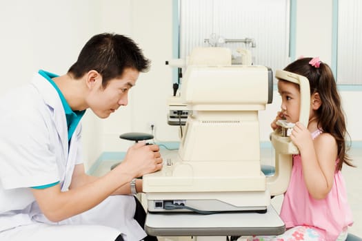 Side profile of an optometrist examining a patient