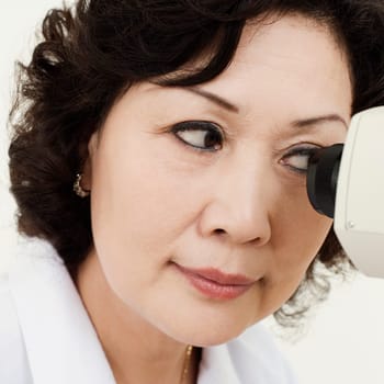 Close-up of an optometrist looking into an ophthalmoscope