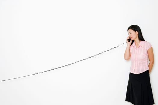 Mid adult woman talking on the telephone