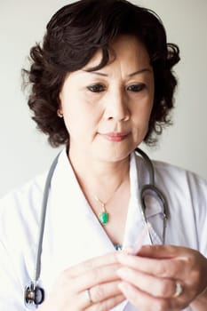 Close-up of a female doctor holding a syringe