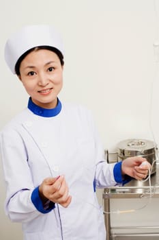 Portrait of a female nurse holding an iv drip