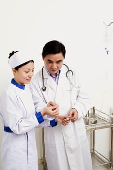 Close-up of a male doctor and female nurse discussing