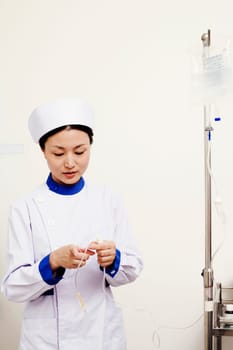Close-up of a female nurse holding an iv drip