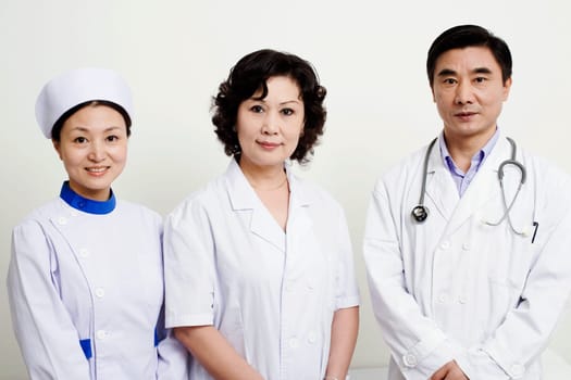 Portrait of a male doctor and a female doctor with a female nurse