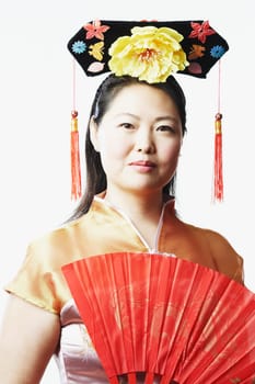 Portrait of a mid adult woman holding a folding fan