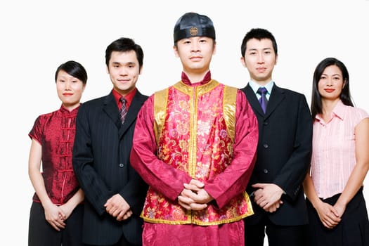 Portrait of four business executives and a young man standing together