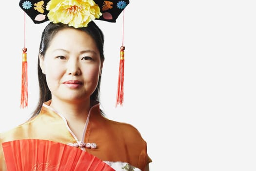 Portrait of a mid adult woman holding a folding fan
