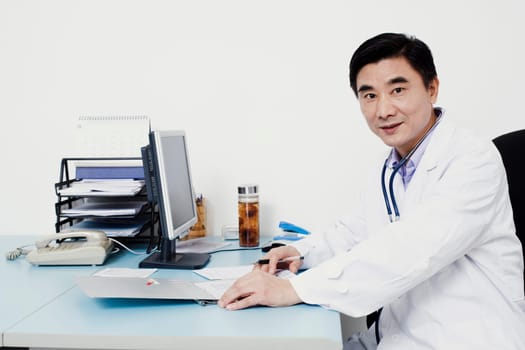 Portrait of a male doctor sitting at the table