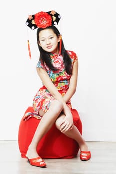 Portrait of a teenage girl sitting on a stool