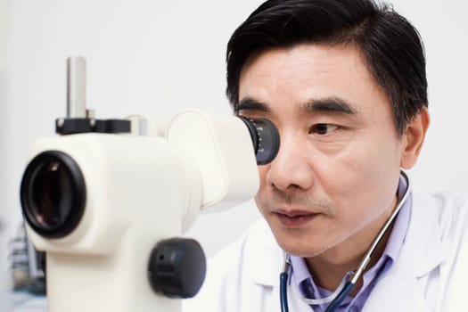 Close-up of an optometrist looking into an ophthalmoscope
