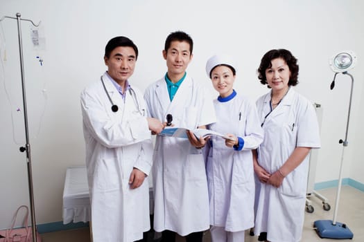 Portrait of two male doctors and a female doctor with a female nurse