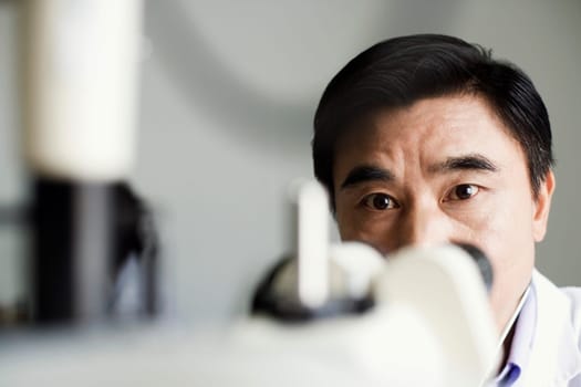 Close-up of an optometrist in front of an ophthalmoscope