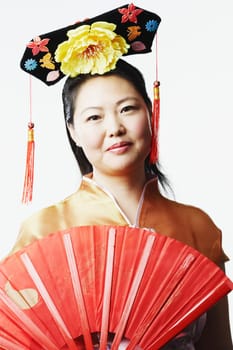 Portrait of a mid adult woman holding a folding fan