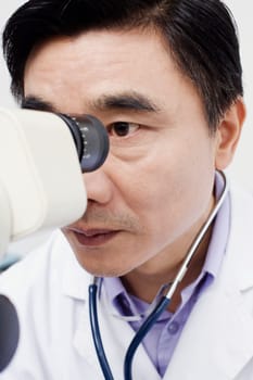 Close-up of an optometrist looking into an ophthalmoscope