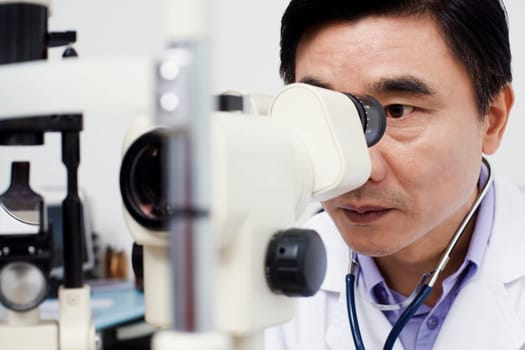 Close-up of an optometrist looking into an ophthalmoscope