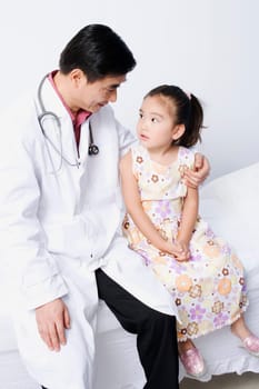 Close-up of a male doctor sitting with a girl