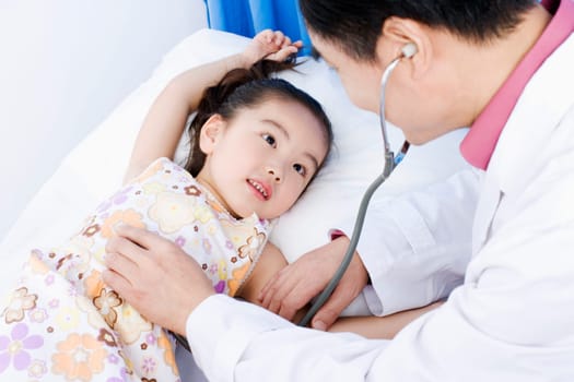 Close-up of a girl being examined by a male doctor