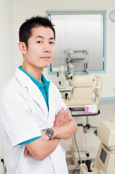 Portrait of a male doctor standing with his arms crossed