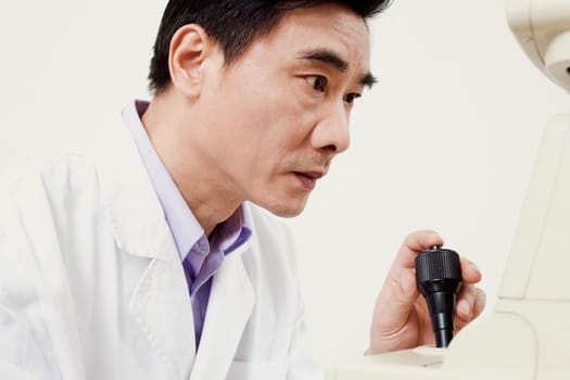 Close-up of an optometrist operating an ophthalmoscope